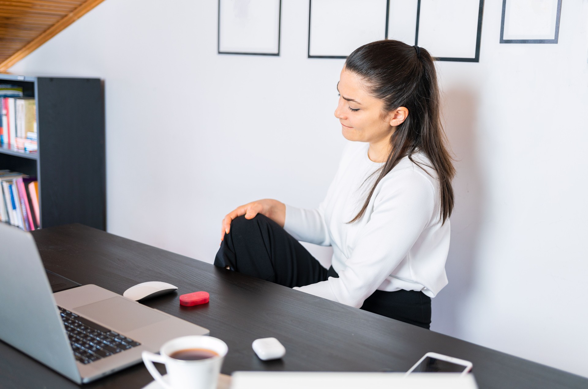 Business woman is suffering from knee pain at home office . Office syndrome knee pain by occupational disease.
