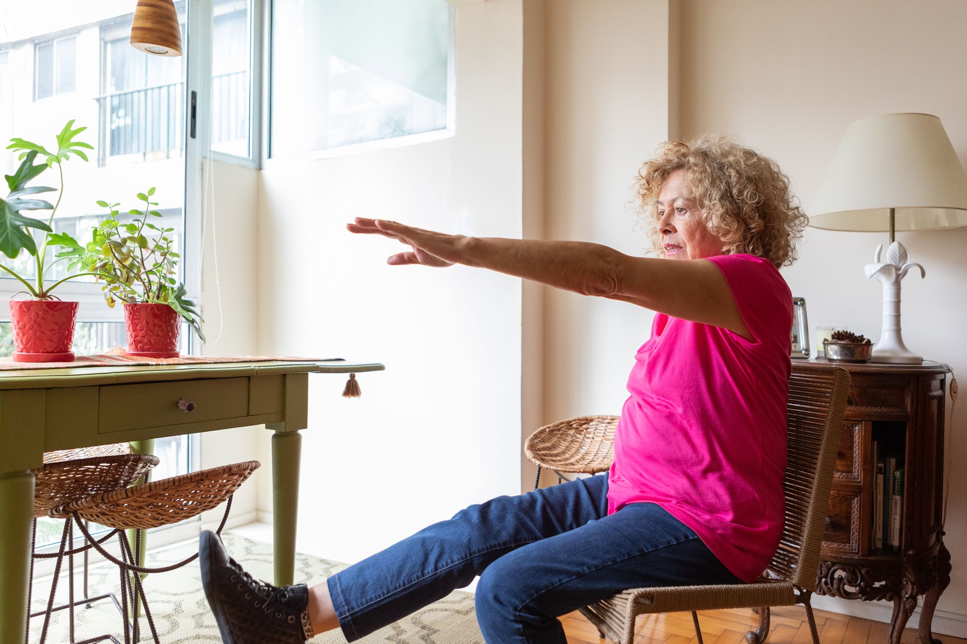 Senior woman doing physical therapy exercises at home